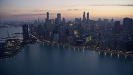4K aerial stock footage a reverse view of waterfront skyscrapers at twilight, Downtown Chicago, Illinois Aerial Stock Footage | AX0170_0056