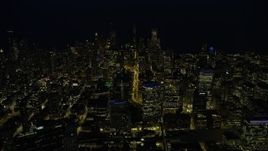 4K aerial stock footage of approaching downtown skyscrapers, some with holiday lights at night, Downtown Chicago, Illinois Aerial Stock Footage | AX0170_0074