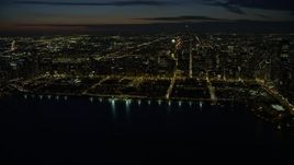4K aerial stock footage of a wide view of Grant Park and downtown skyscrapers, some with holiday lights at night, Downtown Chicago, Illinois Aerial Stock Footage | AX0170_0078