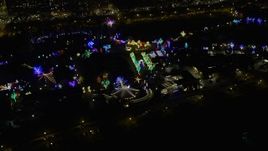 4K aerial stock footage approach and flyby Lincoln Park Zoo, lit with holiday lights at night, Chicago, Illinois Aerial Stock Footage | AX0170_0089