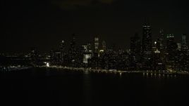 4K aerial stock footage the city's skyline seen from the lake at night, Downtown Chicago, Illinois Aerial Stock Footage | AX0170_0092