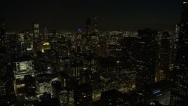 4K aerial stock footage tilt from the lake and ascend over downtown skyscrapers at night, Downtown Chicago, Illinois Aerial Stock Footage | AX0170_0093