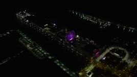 4K aerial stock footage of tilting to a bird's eye view of the Ferris wheel on Navy Pier at night, Chicago, Illinois Aerial Stock Footage | AX0170_0094