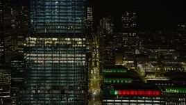 4K aerial stock footage of flying by city canyons and streets at night, Downtown Chicago, Illinois Aerial Stock Footage | AX0170_0100