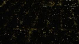 4K aerial stock footage of flying past urban neighborhoods on the West Side at night, Chicago, Illinois Aerial Stock Footage | AX0170_0103