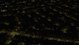4K aerial stock footage of passing urban neighborhoods on the Northwest Side at night, Chicago, Illinois Aerial Stock Footage | AX0170_0107
