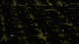 4K aerial stock footage tilt to homes with holiday decorations on the Northwest Side at night, Chicago, Illinois Aerial Stock Footage | AX0170_0109