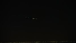 4K aerial stock footage of tracking a commercial jet over the Northwest Side at night, Chicago, Illinois Aerial Stock Footage | AX0170_0110