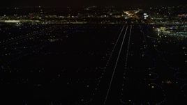 4K aerial stock footage a reverse view of the runways at O'Hare International Airport at night, Chicago, Illinois Aerial Stock Footage | AX0170_0114