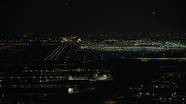 4K aerial stock footage a wide view of the runways and terminals at O'Hare International Airport at night, Chicago, Illinois Aerial Stock Footage | AX0170_0115