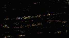 4K aerial stock footage of suburban homes decorated for the holidays at night in Itasca, Illinois Aerial Stock Footage | AX0170_0117