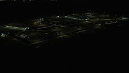 4K aerial stock footage of passing Stateville Correctional Center prison at night, Crest Hill, Illinois Aerial Stock Footage | AX0170_0130