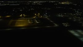 4K aerial stock footage of flying toward Lewis University Airport at night, Romeoville, Illinois Aerial Stock Footage | AX0170_0133