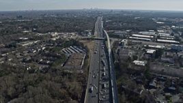 6.7K aerial stock footage tilt from heavy I-75 traffic to a wide view of the distant Atlanta skyline, Marietta, Georgia Aerial Stock Footage | AX0171_0003