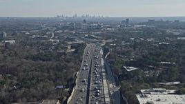 6.7K aerial stock footage tilt from heavy I-75 traffic to reveal a wide view of the distant Atlanta skyline, Marietta, Georgia Aerial Stock Footage | AX0171_0004