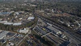6.7K aerial stock footage fly over apartment buildings by train yard to reveal warehouse buildings in Decatur, Georgia Aerial Stock Footage | AX0171_0129