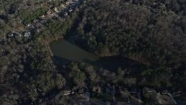 6.7K aerial stock footage of tilt to a small lake by suburban homes in Lawrenceville, Georgia Aerial Stock Footage | AX0171_0132