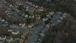 6.7K aerial stock footage of flying away from suburban neighborhoods at sunset, Lawrenceville, Georgia Aerial Stock Footage | AX0171_0138