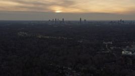 6.7K aerial stock footage tilt from residential neighborhoods to reveal the Atlanta skyline at sunset, Georgia Aerial Stock Footage | AX0171_0142