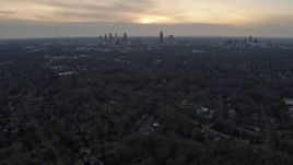 6.7K aerial stock footage of tilting from suburban neighborhoods to reveal Downtown and Midtown at sunset, Atlanta, Georgia Aerial Stock Footage | AX0171_0150