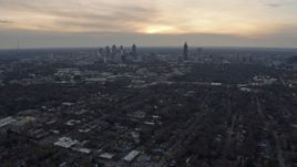6.7K aerial stock footage of tilting from urban neighborhoods to reveal the Downtown Atlanta skyline at sunset, Georgia Aerial Stock Footage | AX0171_0152