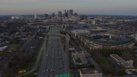6.7K aerial stock footage tilt from freeway to reveal Downtown Atlanta skyline at sunset, Georgia Aerial Stock Footage | AX0171_0158