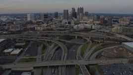 6.7K aerial stock footage tilt from freeway interchange to reveal Downtown Atlanta skyline at sunset, Georgia Aerial Stock Footage | AX0171_0159
