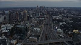 6.7K aerial stock footage tilt from freeway to reveal Midtown and Downtown Atlanta at sunset, Georgia Aerial Stock Footage | AX0171_0183