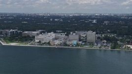 6.7K aerial stock footage of flying by a waterfront hospital in Miami, Florida Aerial Stock Footage | AX0172_007
