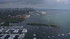 6.7K aerial stock footage tilting from boats in the water to reveal distant skyline of Downtown Miami, Florida Aerial Stock Footage | AX0172_014
