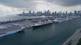 6.7K aerial stock footage of following MacArthur Causeway past cruise ships at Port of Miami, Florida Aerial Stock Footage | AX0172_022