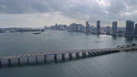 6.7K aerial stock footage fly over causeway to approach the Downtown Miami skyline, Florida Aerial Stock Footage | AX0172_078