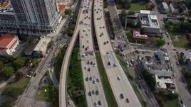 6.7K aerial stock footage tilt from heavy traffic on I-95, reveal tall skyscrapers in Downtown Miami, Florida Aerial Stock Footage | AX0172_112