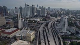 6.7K aerial stock footage tilt from bird's eye of traffic on I-95, approach tall skyscrapers in Downtown Miami, Florida Aerial Stock Footage | AX0172_113