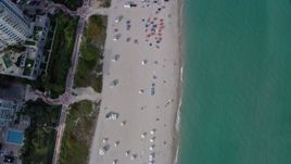 6.7K aerial stock footage a view of a bird's eye view of sunbathers in South Beach, Miami, Florida Aerial Stock Footage | AX0172_135
