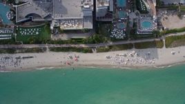6.7K aerial stock footage a view of a bird's eye view of sunbathers in South Beach, Miami, Florida Aerial Stock Footage | AX0172_136