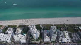 6.7K aerial stock footage of flying by sunbathers on the beach in Miami Beach, Florida Aerial Stock Footage | AX0172_140