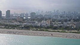 6.7K aerial stock footage of passing by South Beach, Florida with the Miami skyline in the distance Aerial Stock Footage | AX0172_143