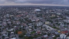 6.7K aerial stock footage fly over Little Havana neighborhood to approach stadium at sunset, Miami, Florida Aerial Stock Footage | AX0172_177