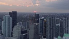 6.7K aerial stock footage of the setting sun behind Downtown Miami skyscrapers, Miami, Florida Aerial Stock Footage | AX0172_186