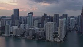 6.7K aerial stock footage a view of the setting sun behind waterfront skyscrapers in Downtown Miami, Miami, Florida Aerial Stock Footage | AX0172_188