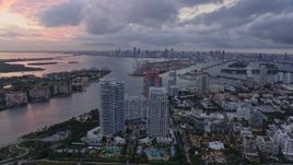 6.7K aerial stock footage flyby South Beach at sunset, with view or the port and Downtown Miami, Florida Aerial Stock Footage | AX0172_196