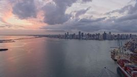 6.7K aerial stock footage fly over the port and Biscayne Bay toward Downtown Miami skyline at sunset, Florida Aerial Stock Footage | AX0172_198