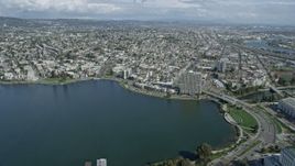 6K aerial stock footage of flying over Lake Merritt toward urban neighborhoods, Oakland, California Aerial Stock Footage | AX0173_0011