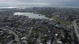 6K aerial stock footage of approach Lake Merritt and downtown from urban neighborhoods, Oakland, California Aerial Stock Footage | AX0173_0013