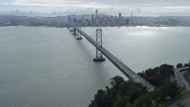 6K aerial stock footage tilt from traffic on the Bay Bridge to reveal Downtown San Francisco skyline, California Aerial Stock Footage | AX0173_0032
