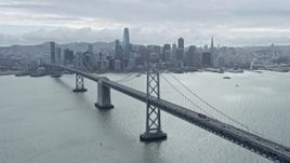 6K aerial stock footage following the Bay Bridge toward Downtown San Francisco skyline, California Aerial Stock Footage | AX0173_0033
