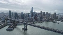 6K aerial stock footage flying by the Bay Bridge toward Downtown San Francisco skyline, California Aerial Stock Footage | AX0173_0035