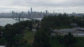 6K aerial stock footage fly over Coast Guard pier on Yerba Buena Island, reveal Downtown San Francisco skyline, California Aerial Stock Footage | AX0173_0072