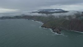 6K aerial stock footage of approaching fog-wreathed coastal cliffs, Marin Headlands, California Aerial Stock Footage | AX0173_0098